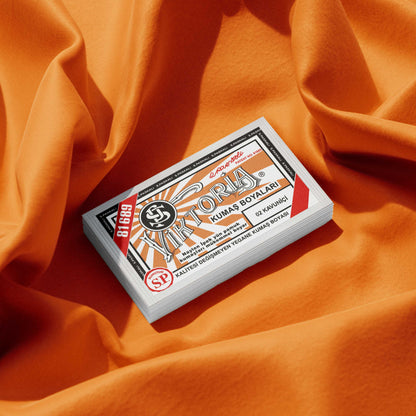 Pack of melon orange fabric dye placed on a vibrant orange fabric background